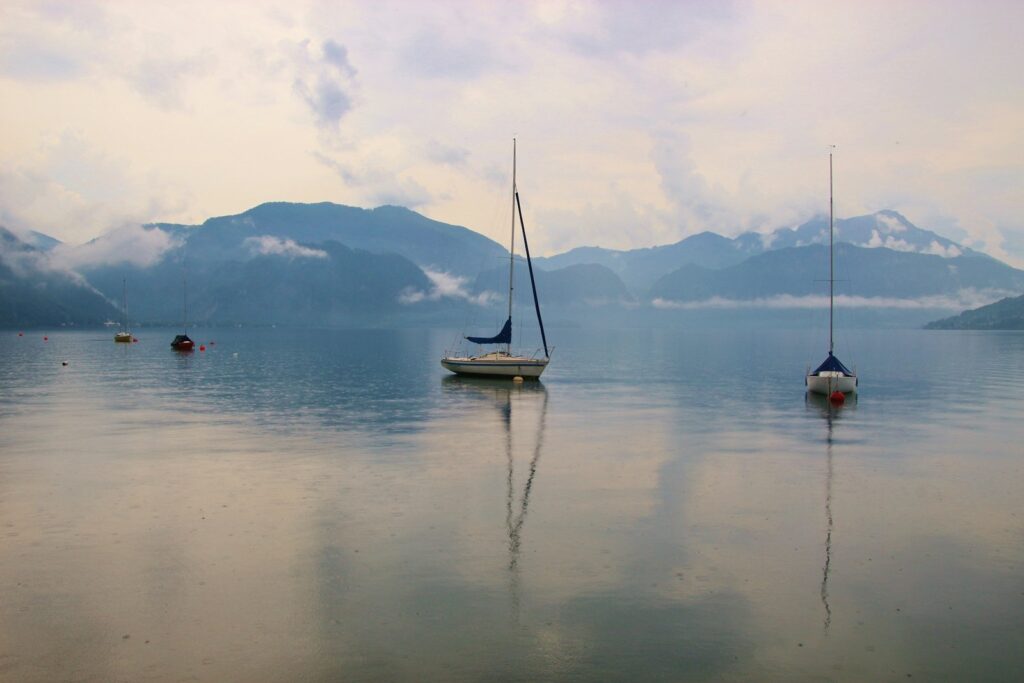 white boat on body of water during daytime